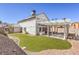 Spacious backyard with a covered patio, artificial turf, and gravel landscaping at 1209 Shifting Sands Dr, Las Vegas, NV 89108