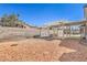 Large backyard features a pergola, gravel landscaping, and block wall surround at 1209 Shifting Sands Dr, Las Vegas, NV 89108
