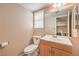 Functional bathroom featuring a window, a vanity with storage, and a toilet at 1209 Shifting Sands Dr, Las Vegas, NV 89108