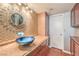 Bathroom with unique blue glass bowl sink and decorative mirror at 1209 Shifting Sands Dr, Las Vegas, NV 89108