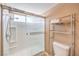 Shower with glass doors, white tile surround, and silver metal shelving, along with a toilet at 1209 Shifting Sands Dr, Las Vegas, NV 89108