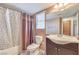 Cozy bathroom with combined shower and tub, floral shower curtain, and dark vanity at 1209 Shifting Sands Dr, Las Vegas, NV 89108