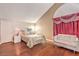 Bright bedroom with wood floors, red curtains, and comfortable furniture at 1209 Shifting Sands Dr, Las Vegas, NV 89108