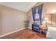 Well-lit room with hardwood floors, window with blinds and curtains, and vaulted ceiling at 1209 Shifting Sands Dr, Las Vegas, NV 89108