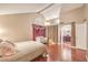 Bedroom featuring stylish wallpaper, wood floors, and access to the bathroom at 1209 Shifting Sands Dr, Las Vegas, NV 89108