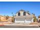Charming two-story home featuring a three-car garage and well-maintained front yard at 1209 Shifting Sands Dr, Las Vegas, NV 89108