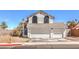 Charming two-story home with a three-car garage and well-maintained landscaping at 1209 Shifting Sands Dr, Las Vegas, NV 89108