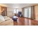 Comfortable living room with brick fireplace, wood floors, and ample natural light at 1209 Shifting Sands Dr, Las Vegas, NV 89108