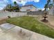 Well-manicured backyard featuring a lawn and a charming fountain, perfect for outdoor relaxation and entertaining at 141 Fox Lake Ave, Las Vegas, NV 89148