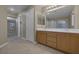 Bright bathroom featuring a double sink vanity, tile floors, and a walk-in shower at 141 Fox Lake Ave, Las Vegas, NV 89148