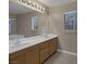 Bathroom featuring double sinks, large mirror and modern lighting at 141 Fox Lake Ave, Las Vegas, NV 89148
