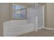Bathroom features soaking tub and separate shower with glass door at 141 Fox Lake Ave, Las Vegas, NV 89148
