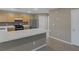 Eat-in kitchen featuring stainless steel appliances, breakfast bar, and smooth tile floors at 141 Fox Lake Ave, Las Vegas, NV 89148