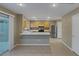 Well-lit kitchen with stainless steel appliances, breakfast bar, and smooth tile flooring at 141 Fox Lake Ave, Las Vegas, NV 89148