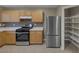 Kitchen with stainless steel appliances and shelving and plenty of cabinet space at 141 Fox Lake Ave, Las Vegas, NV 89148
