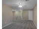 Spacious living room featuring neutral carpeting, ceiling fan and access to the second floor at 141 Fox Lake Ave, Las Vegas, NV 89148