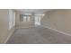 Comfortable living room featuring neutral walls and plush carpet, seamlessly flowing to other rooms at 141 Fox Lake Ave, Las Vegas, NV 89148