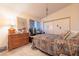 Cozy bedroom features a large dresser, patterned bedspread, and a sliding-door closet at 1892 Maricopa Dr, Laughlin, NV 89029