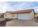 Cozy single-story home featuring a tile roof, neutral stucco and an attached two-car garage at 1892 Maricopa Dr, Laughlin, NV 89029