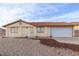 Single-story home with a tile roof, neutral stucco and a spacious two-car garage at 1892 Maricopa Dr, Laughlin, NV 89029