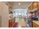 Galley-style kitchen with oak cabinets, black appliances, and a connecting dining area with natural light at 1892 Maricopa Dr, Laughlin, NV 89029