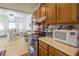 View of the kitchen featuring wood cabinets, black appliances, and dining area with lots of natural light at 1892 Maricopa Dr, Laughlin, NV 89029