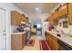 Spacious kitchen with wooden cabinets, updated appliances, and a view into the living room at 1892 Maricopa Dr, Laughlin, NV 89029