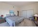 Cozy main bedroom featuring carpeted floors, natural light, and sliding mirrored closet doors at 1892 Maricopa Dr, Laughlin, NV 89029