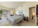 Comfortable main bedroom featuring carpeted floors, ample natural light, and sliding glass door at 1892 Maricopa Dr, Laughlin, NV 89029