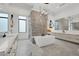 Primary bathroom featuring a freestanding tub, dual sinks, and a walk-in shower at 20 Pebble Hills Ct, Las Vegas, NV 89141