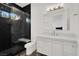 Modern bathroom features a black tiled shower with glass door, white vanity, and patterned floor at 20 Pebble Hills Ct, Las Vegas, NV 89141