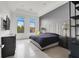 Serene bedroom with modern decor, a grey accent wall, and lots of natural light at 20 Pebble Hills Ct, Las Vegas, NV 89141