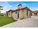 Mediterranean home boasts mature trees, manicured lawn, and lush landscaping at 20 Pebble Hills Ct, Las Vegas, NV 89141