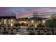 Beautiful exterior of home with desert landscaping and lighted walkway at 20 Pebble Hills Ct, Las Vegas, NV 89141
