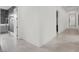A bright hallway with tiled floors leading to a bathroom with patterned wallpaper at 20 Pebble Hills Ct, Las Vegas, NV 89141