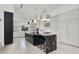 Sleek modern kitchen with black waterfall island, stainless steel appliances, and custom cabinetry at 20 Pebble Hills Ct, Las Vegas, NV 89141