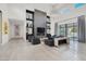 Elegant living room with tall ceilings, wall fireplace, clerestory windows, and backyard views at 20 Pebble Hills Ct, Las Vegas, NV 89141