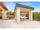 Shaded patio features comfortable seating and views of the lush backyard at 20 Pebble Hills Ct, Las Vegas, NV 89141