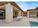 Gorgeous patio includes an outdoor kitchen, dining area, and shaded swing for relaxing at 20 Pebble Hills Ct, Las Vegas, NV 89141