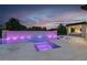 Inviting pool with waterfall feature, hot tub, sun loungers, and a covered outdoor kitchen and bar area at 20 Pebble Hills Ct, Las Vegas, NV 89141