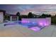 Stunning swimming pool features chaise lounges, a sun shelf, and colorful accent lighting at 20 Pebble Hills Ct, Las Vegas, NV 89141