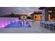 Serene outdoor space with pool, spa, covered patio, outdoor kitchen, and dining area for luxury living at 20 Pebble Hills Ct, Las Vegas, NV 89141