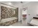 The bathroom features a modern tub with a mosaic tile surround and glass door at 200 Hoover Ave # 1507, Las Vegas, NV 89101