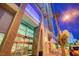 Modern building entrance with glass doors, concrete accents, and ample natural light near palm trees at 200 Hoover Ave # 1507, Las Vegas, NV 89101
