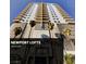 Striking exterior view of the Newport Lofts high-rise in Las Vegas with modern architectural design and palm trees at 200 Hoover Ave # 1507, Las Vegas, NV 89101