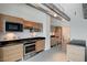 Modern kitchen features stainless steel appliances, wood cabinets and black countertops at 200 Hoover Ave # 1507, Las Vegas, NV 89101