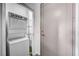 Convenient laundry area features a stacked washer and dryer, plus shelving at 200 Hoover Ave # 1507, Las Vegas, NV 89101