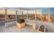 Rooftop terrace with benches, planters, and a panoramic view of the city at sunset at 200 Hoover Ave # 1507, Las Vegas, NV 89101