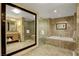 Bathroom boasts marble finishes, soaking tub and double vanity at 2000 N Fashion Show Dr # 3921, Las Vegas, NV 89109