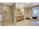 Bathroom featuring walk-in shower, marble floors, and double vanity at 2000 N Fashion Show Dr # 3921, Las Vegas, NV 89109